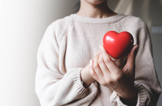 woman holding red heart 